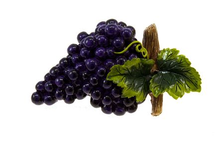 Plaster figurine of dark blue grapes isolated on a white backgroundの写真素材