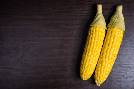 Corn on wood background.の写真素材