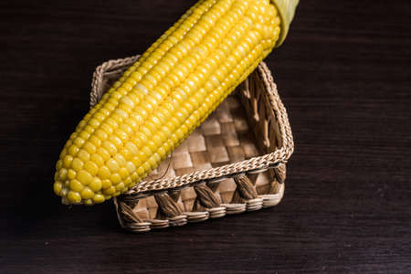 Corn on basket on wood background.の写真素材