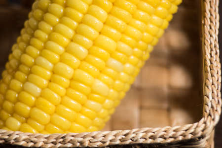 Corn in basket on wood background.の写真素材