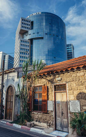 Tel Aviv, Israel - October 20, 2015. Small house with building of Trade Tower on background in historic Neve Tzedek district (lit. Abode of Justice) in southwestern part of Tel Aviv