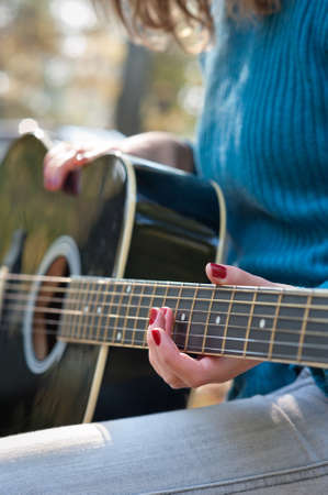 Young girl with acoustic guitarの写真素材