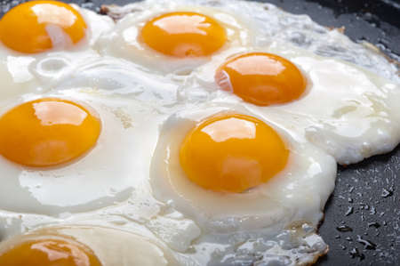 Close up view of the fried egg on a frying panの写真素材