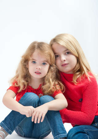 two beautiful little girls on a white backgroundの写真素材