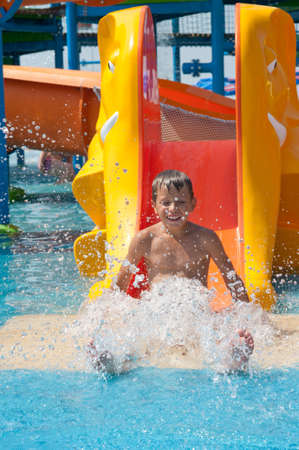 Child on water slide at aquaparkの写真素材