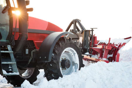 Tractor cleaning snow in fieldの写真素材