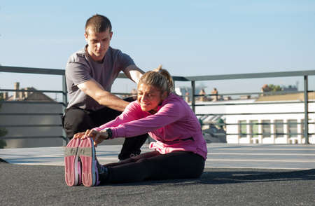 Two young exercise on the roofの写真素材