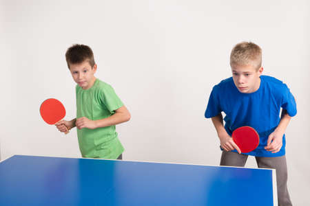 two boys playing table tennisの写真素材