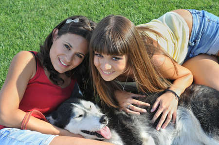 sisters and her faithful huskyの写真素材