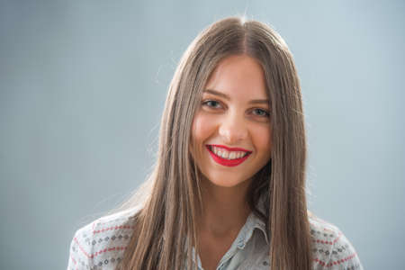 studio portrait of young woman isolated on whiteの写真素材