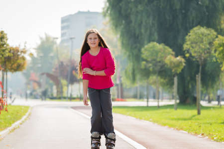 girl rides on roller skatesの写真素材