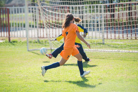 Female soccer player kicking at goalの写真素材