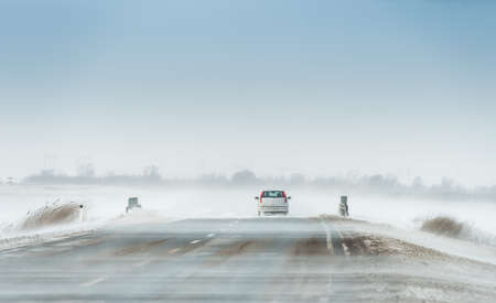 Driving car in a blizzardの写真素材