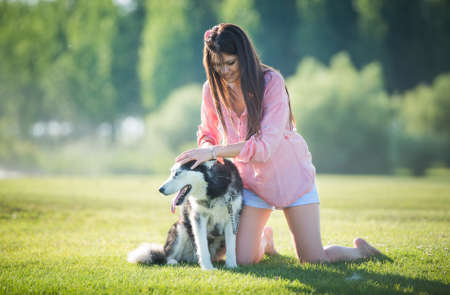 pretty girl caressing her dogの写真素材
