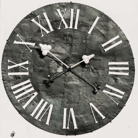 Old rusty big street clock on wall of the building