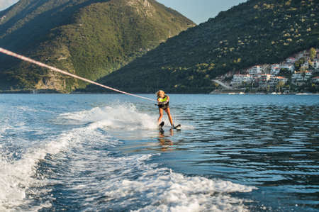 young woman water skiing on a seaの写真素材