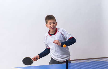 little boy playing table tennisの写真素材
