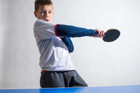 little boy playing table tennisの写真素材