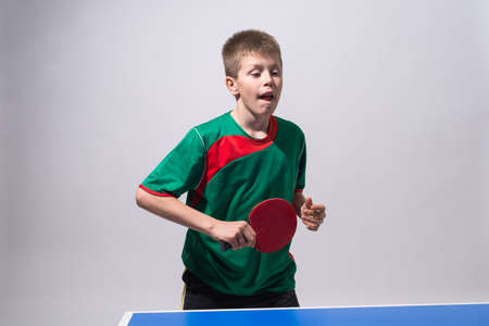 little boy playing table tennisの写真素材