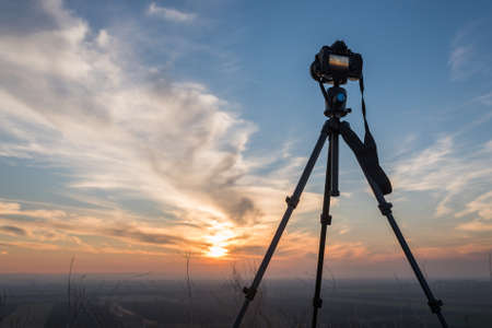 Camera on tripod at sunsetの写真素材