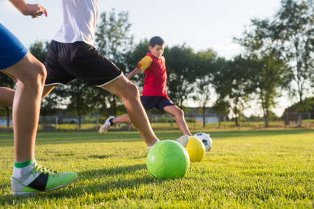 Boys kicking ball at goalの写真素材