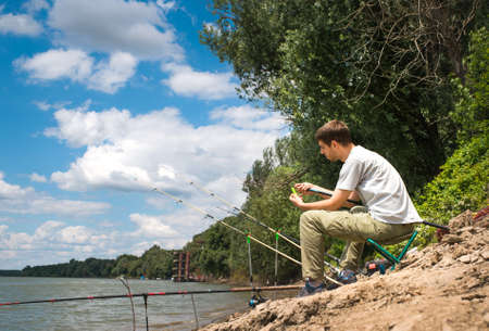 Fisherman on the river bankの写真素材