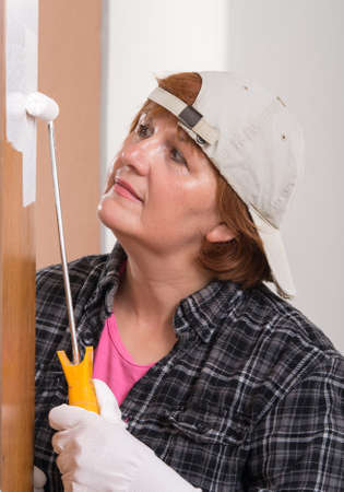 Woman painting door with brushの写真素材