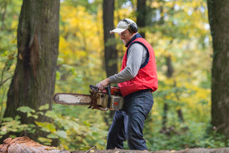 Man cutting a branch with chainsaw