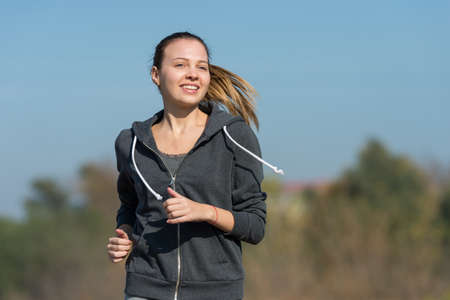 Pretty young girl  jogging in the park