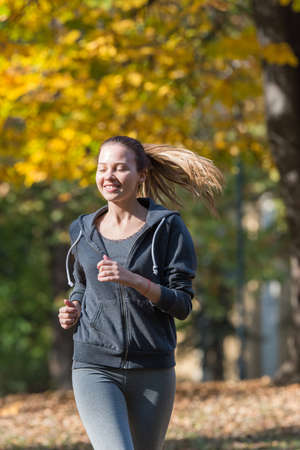 Pretty young girl  jogging in the parkの写真素材