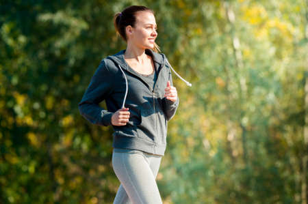 Pretty young girl  jogging in the park