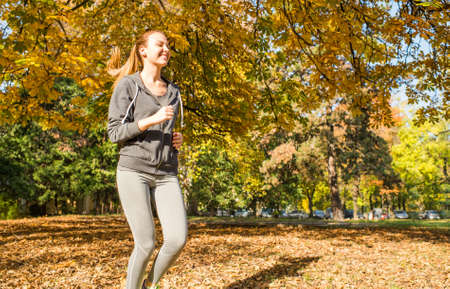 Young girl  jogging in the parkの写真素材