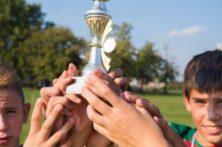 winning the cup in soccer kidsの写真素材