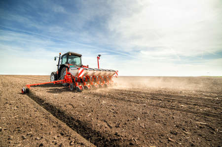 Farmer seeding crops at field