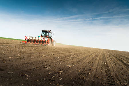 Farmer seeding crops at field