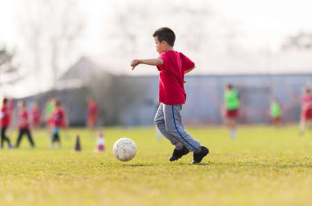 Kids soccer football - young children player match on soccer field の写真素材