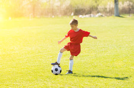 Kids soccer football - young children players match on soccer fieldの写真素材