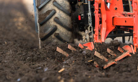 Tractor plowing fields -preparing land for sowingの写真素材