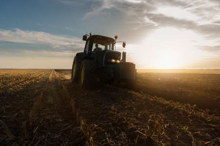 Tractor plowing fields -preparing land for sowingの写真素材