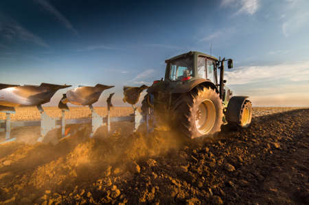 Tractor plowing fields -preparing land for sowing