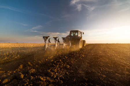 Tractor plowing fields -preparing land for sowing