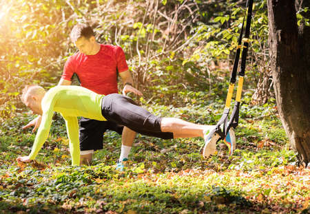 Handsome young men wearing sportswear and exercising in forest at mountain during autumn