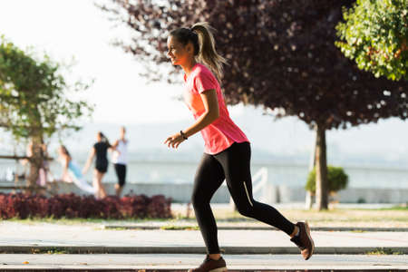Young sporty girl jogging outdoorの写真素材