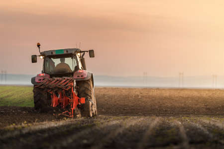 Tractor plowing fields -preparing land for sowingの写真素材
