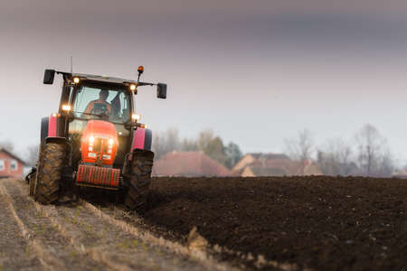Tractor plowing fields -preparing land for sowing