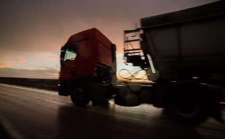 Night drive - truck in motion during sunsetの写真素材