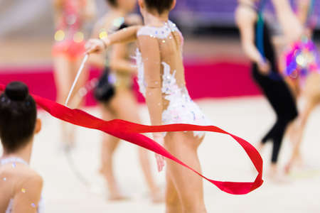 Girl in beautiful gymnastic dress doing exerciseの写真素材