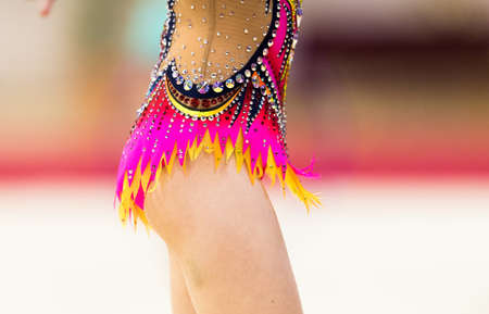 Girl in beautiful gymnastic dress doing exerciseの写真素材