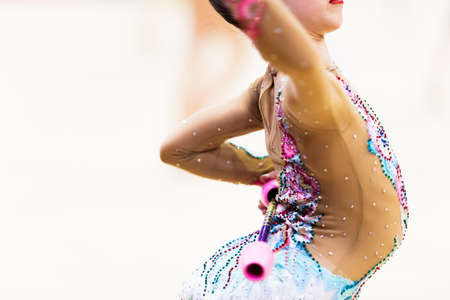 Girl in beautiful gymnastic dress doing exerciseの写真素材
