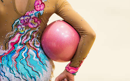 Girl in beautiful gymnastic dress doing exerciseの写真素材